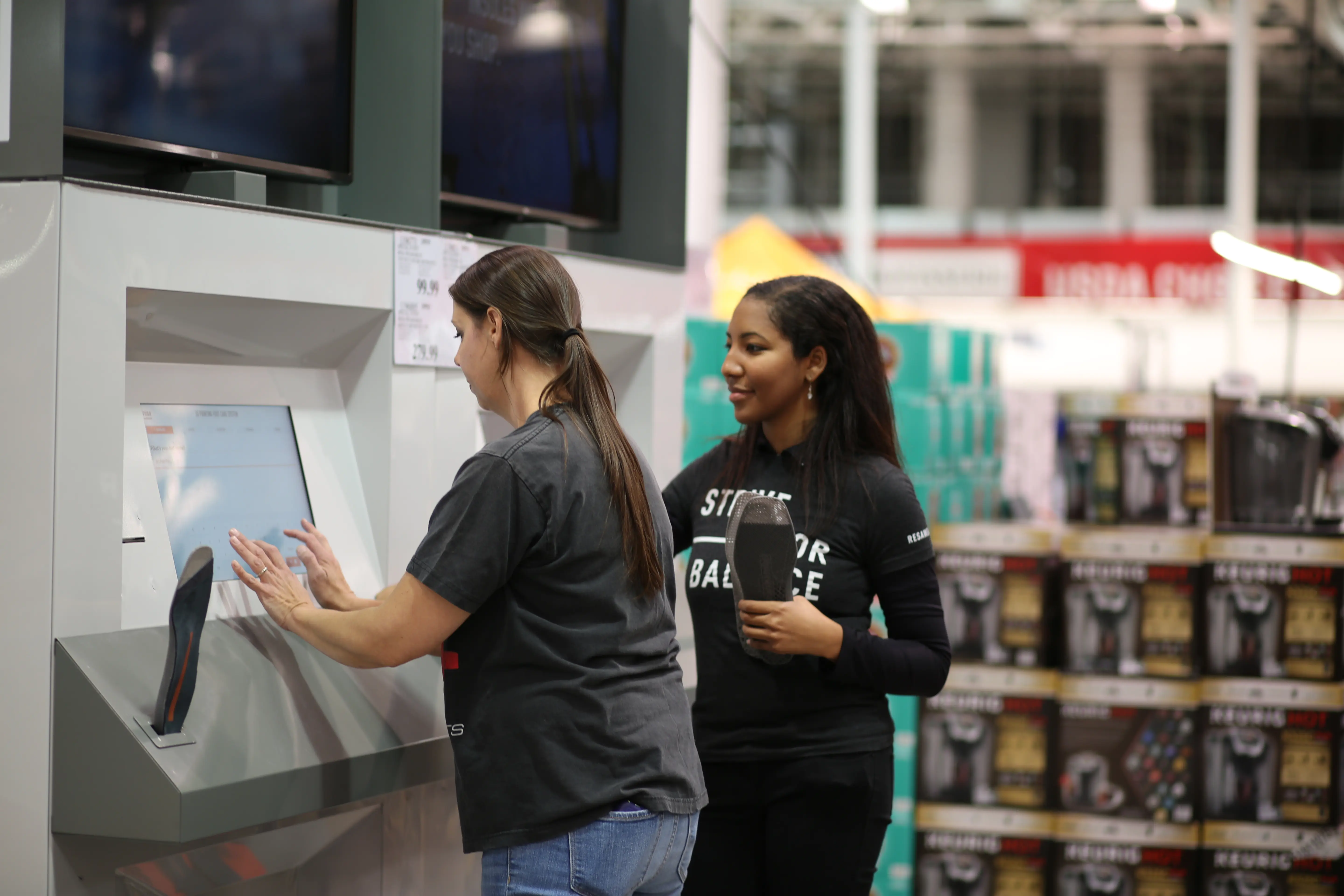 Two people in conversation at a product display