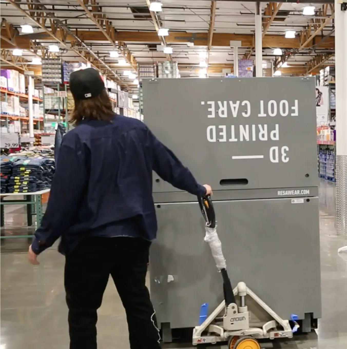 Team member moving equipment through a warehouse club