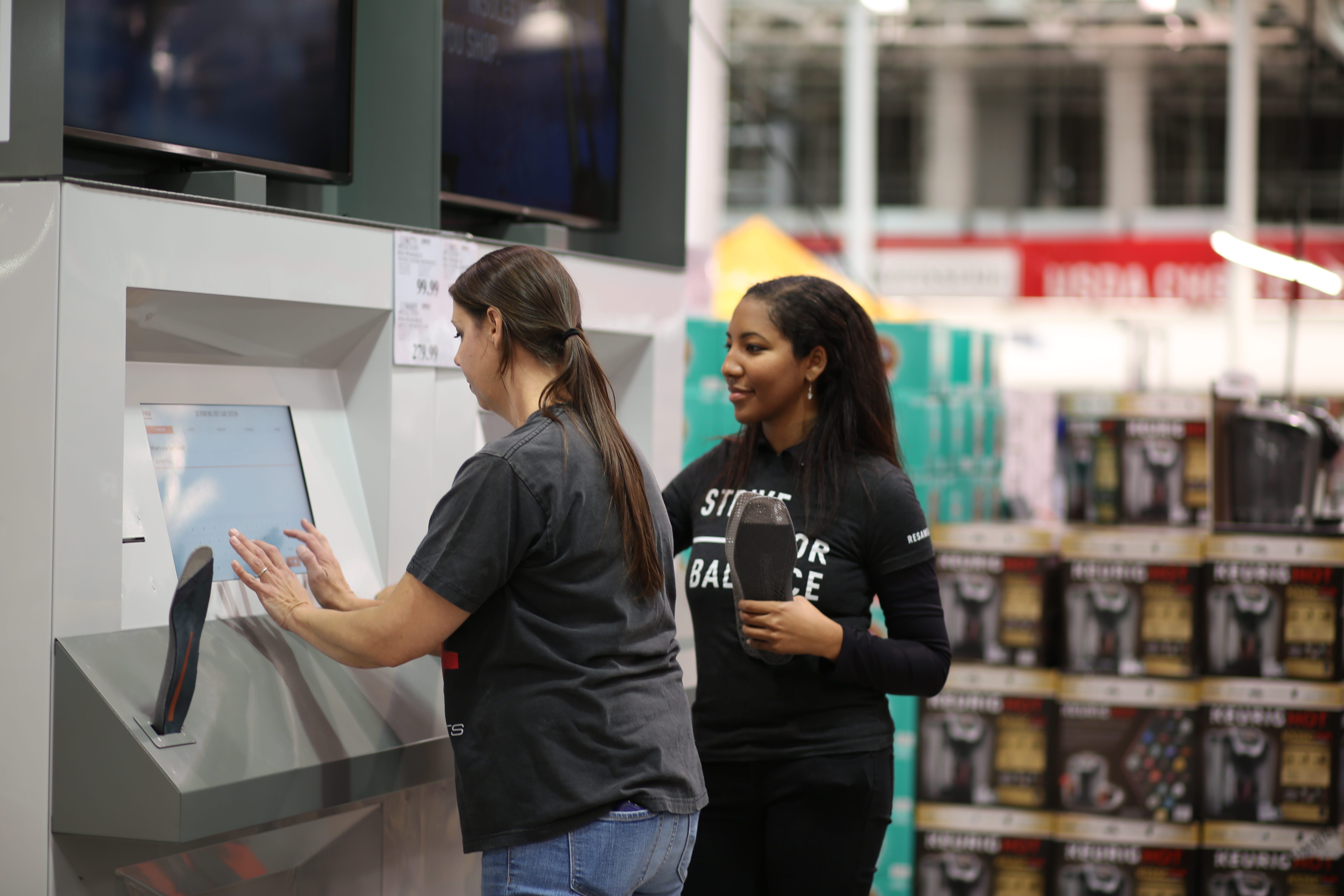 Two people in conversation at a product display